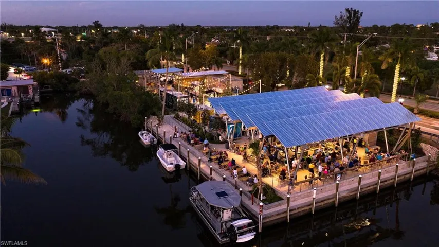 Aerial view at dusk featuring a water view