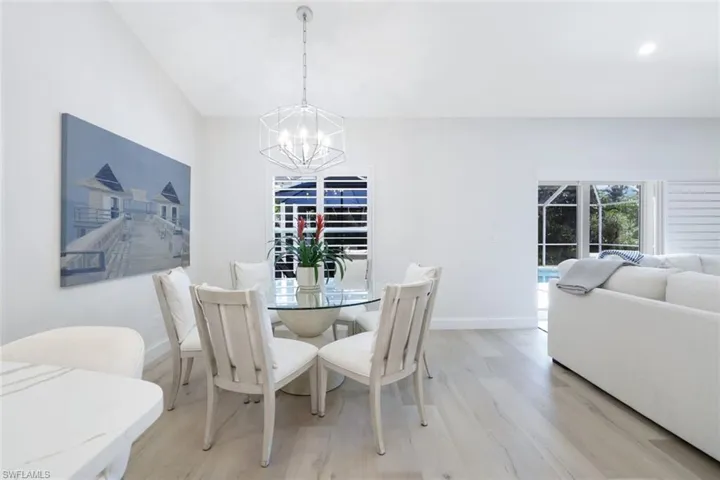 Dining room featuring an inviting chandelier and light wood-type flooring