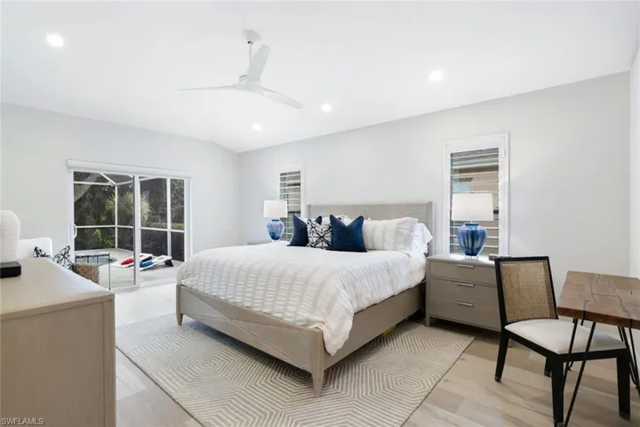 Bedroom with light hardwood / wood-style floors, access to outside, and ceiling fan