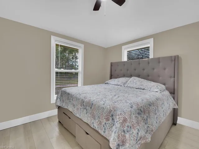 Bedroom with light wood finished floors and ceiling fan