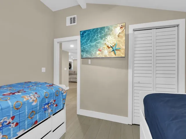 Bedroom featuring light wood-style floors and a closet