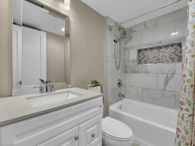 Bathroom with shower / bath combo and vanity