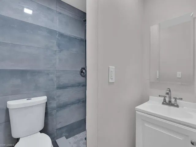 Full bathroom featuring a shower stall and vanity