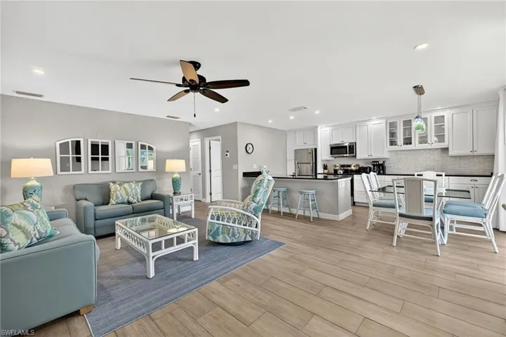 Living room with light wood-style floors, recessed lighting, and a ceiling fan