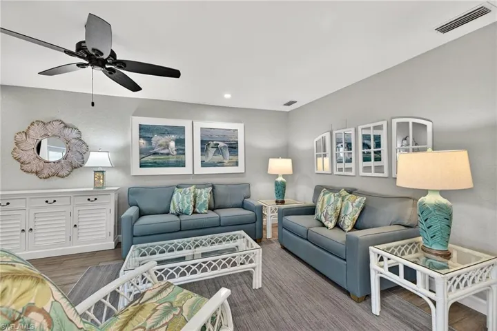 Living area featuring wood finished floors, recessed lighting, and a ceiling fan