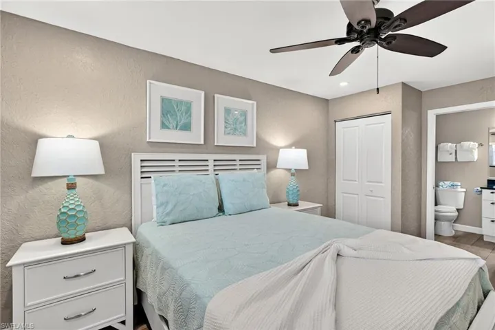 Bedroom featuring a textured wall, a closet, a ceiling fan, connected bathroom, and recessed lighting