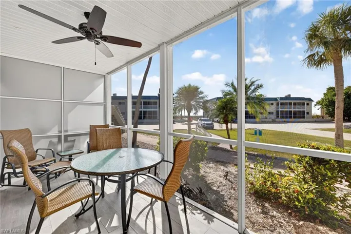Sunroom / solarium featuring ceiling fan and outdoor dining space