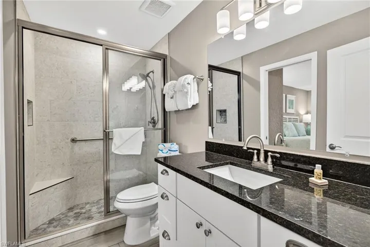 Ensuite bathroom featuring vanity and a stall shower