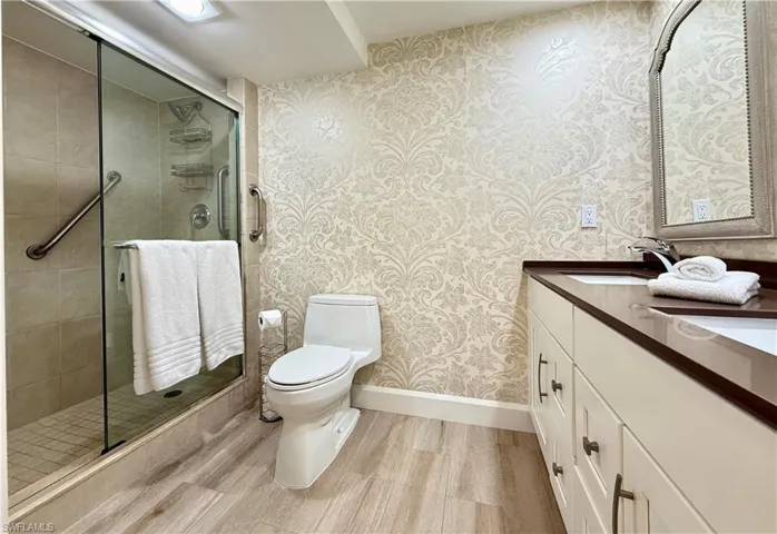 master en suite with step in shower and double sink vanities.