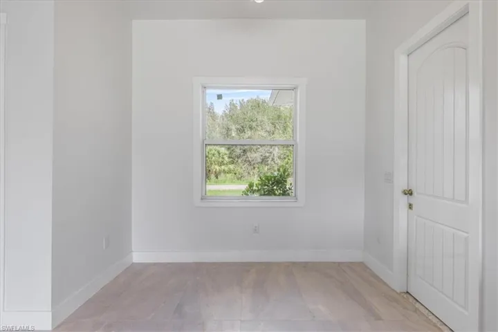Empty room featuring baseboards