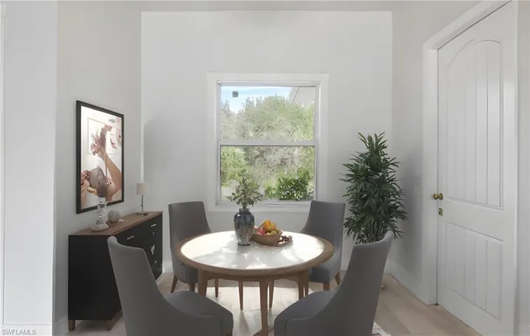 Dining space with light wood-style flooring and baseboards