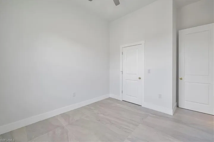 Unfurnished bedroom featuring baseboards and a ceiling fan