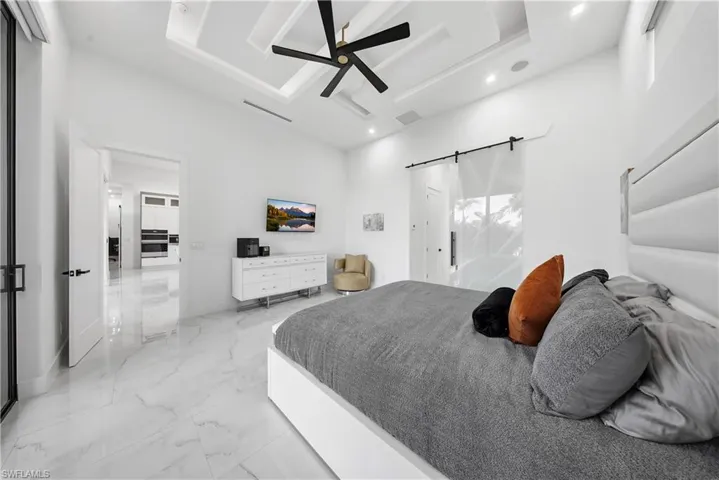 Master Bedroom with a high ceiling ceiling fan, a barn door, and recessed lighting