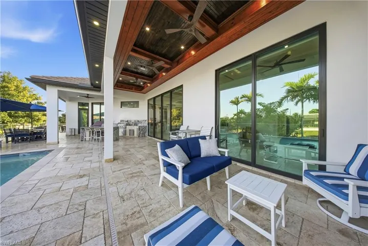 View of patio with a ceiling fan, outdoor lounge area, and an outdoor pool