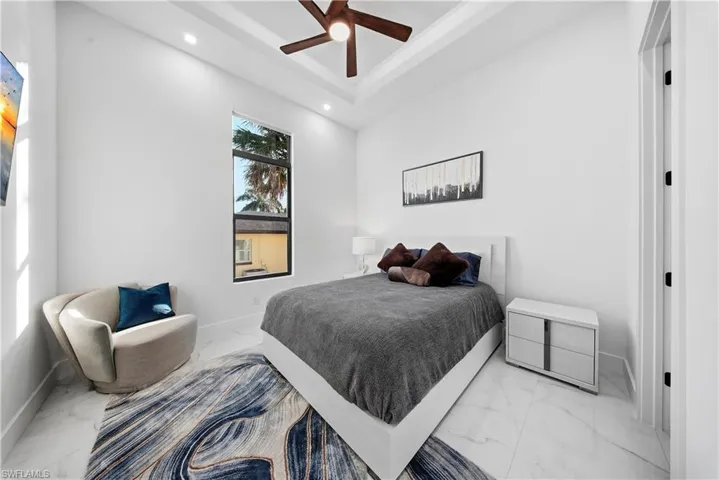 Bedroom featuring a ceiling fan, recessed lighting, and coffered ceiling