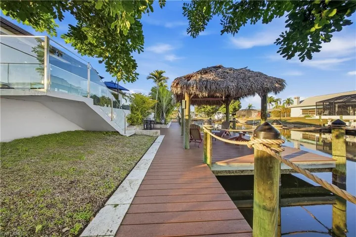 Dock featuring a water view and a yard