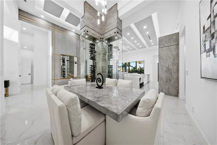 Dining room featuring a high ceiling, recessed lighting, and chandelier.
