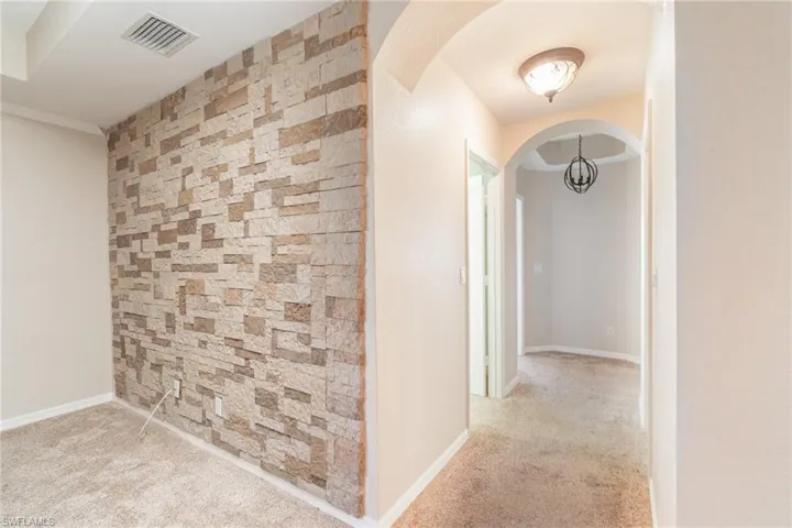 Hallway featuring carpet