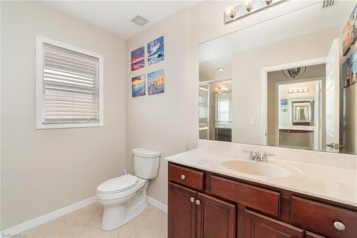 Bathroom with vanity, toilet, and tile patterned floors