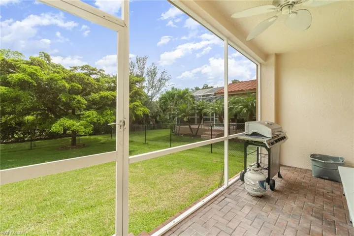 Unfurnished sunroom featuring ceiling fan