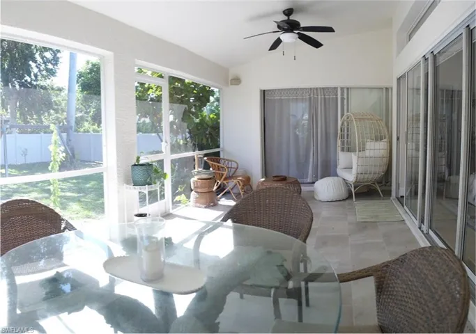 Screened patio featuring a vaulted ceiling and a ceiling fan