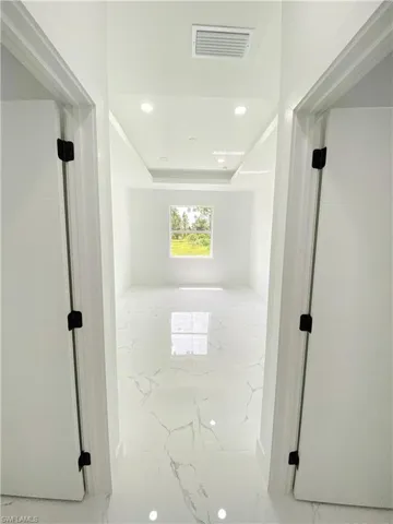 Hallway with light tile patterned flooring