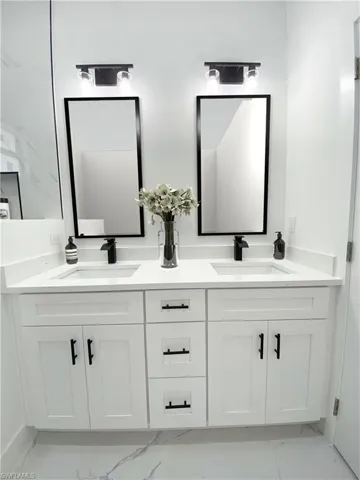Bathroom with tile patterned flooring and vanity