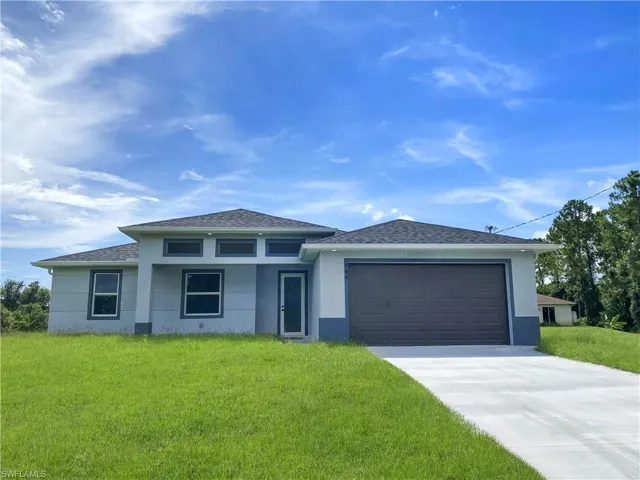 Modern house with a garage and a front lawn