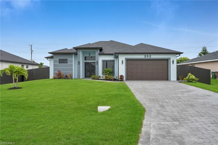 Prairie-style home with stucco siding, decorative driveway, a garage, and a shingled roof