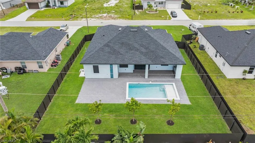 Aerial perspective of suburban area with a pool
