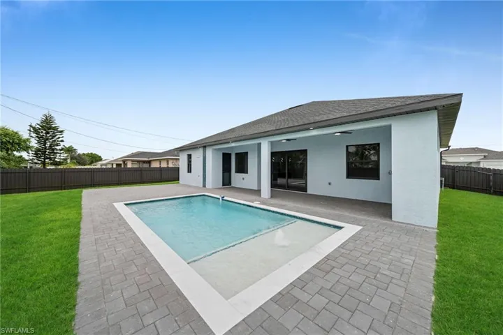 View of pool with a fenced backyard and a patio
