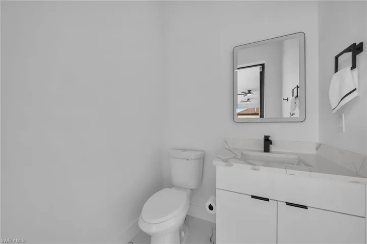Half bath featuring vanity and toilet