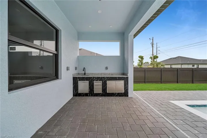 View of patio / terrace with an outdoor kitchen and a sink