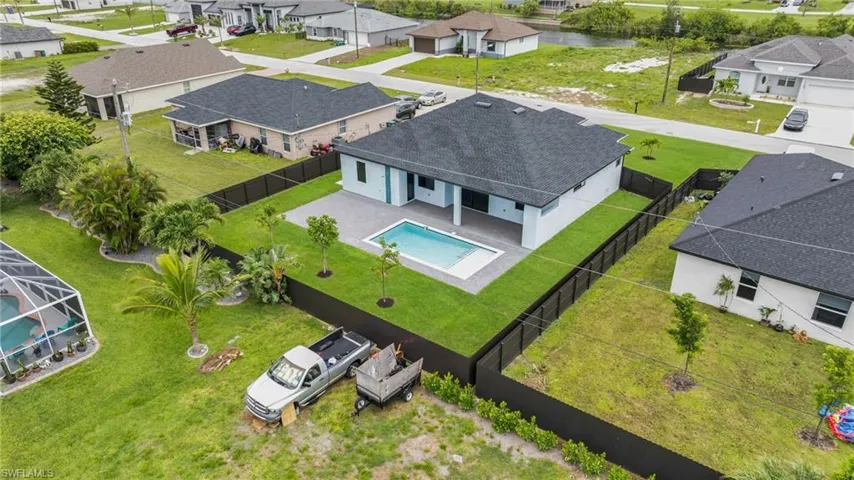 Aerial perspective of suburban area with a pool