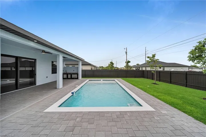 View of pool featuring a fenced backyard, a patio area, and ceiling fan