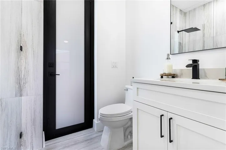 Quartz counter top with white shaker vanity.