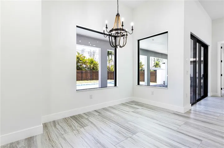 Formal dining overlooks the pool.