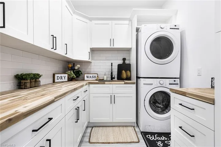 Now, This is a Laundry room/ Pantry! Stackable Full sized  washer/Dryer. Mop sink, custom cabinets and Pantry. Lots of space in here! Butcher block counter tops.