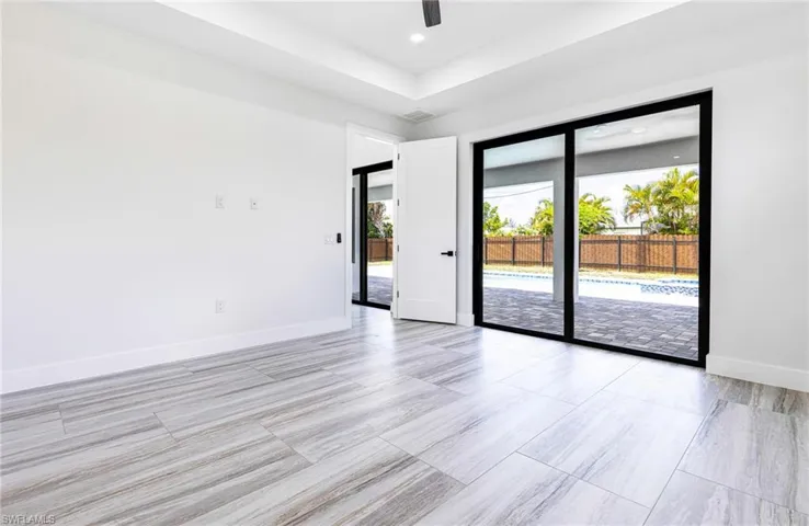 Primary with Tray ceiling and recessed lighting and ceiling fan with light on remote.