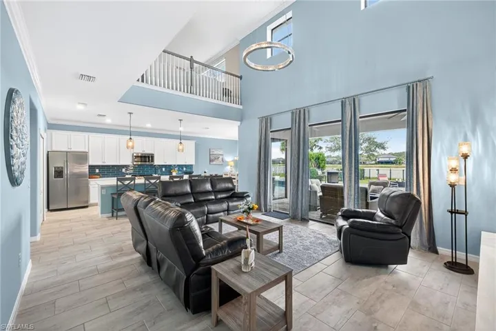 Living area with ornamental molding and a high ceiling