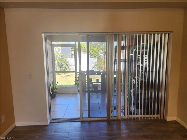 Entryway with baseboards and wood finished floors