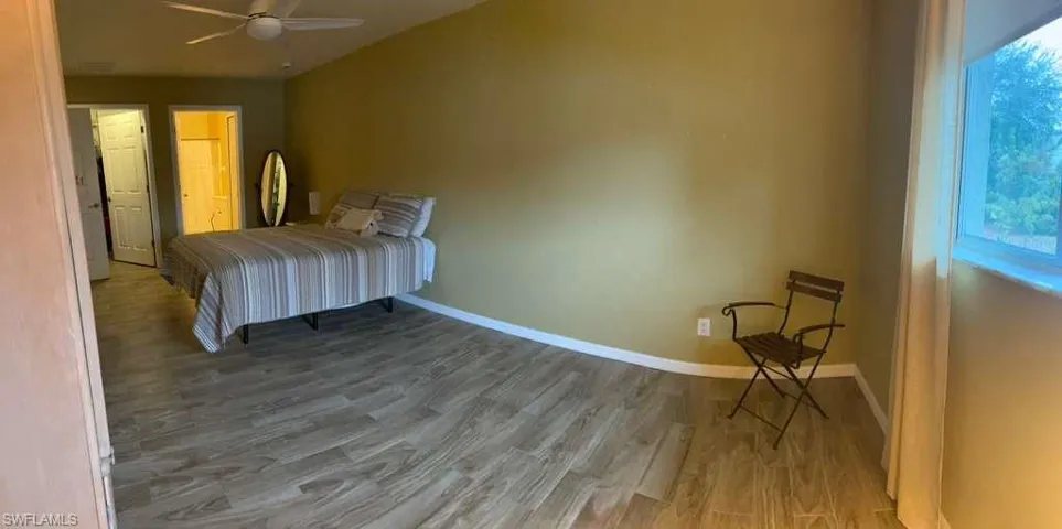 Bedroom with light wood-style flooring and a ceiling fan