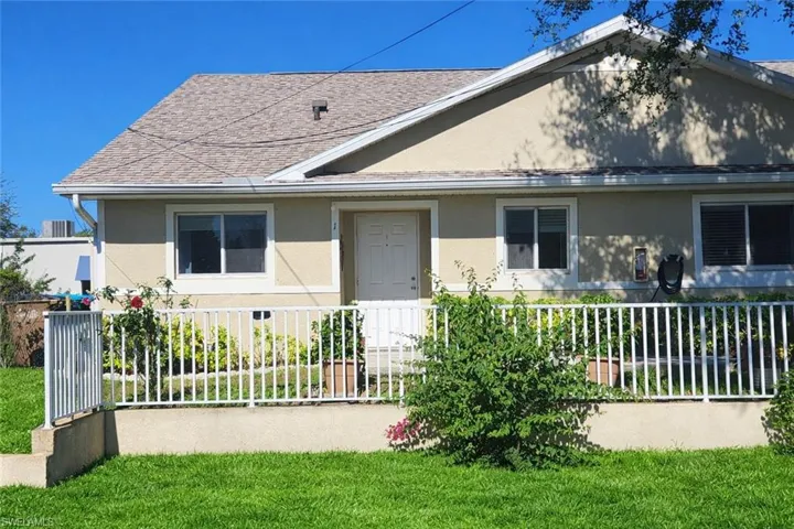 Bungalow-style home featuring a shingled roof and stucco siding