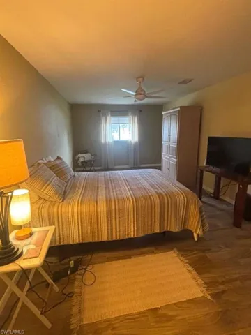 Bedroom featuring wood finished floors and ceiling fan