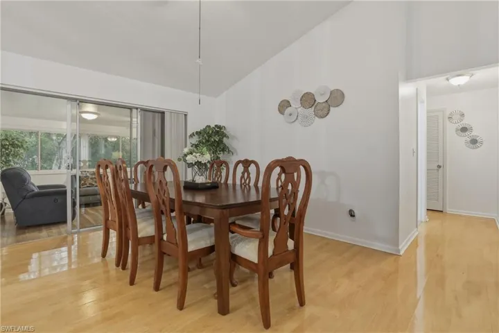 Dining space with lofted ceiling and light wood finished floors