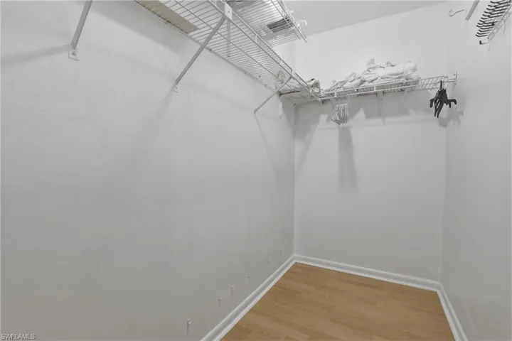 Walk in closet featuring wood finished floors