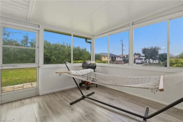 Sunroom / solarium featuring wood finished floors and baseboards