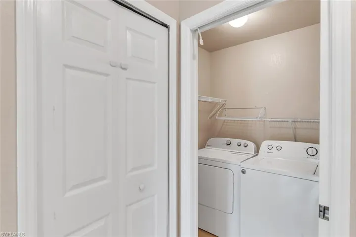 Clothes washing area featuring washer and dryer