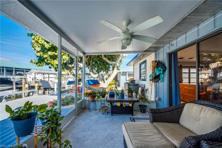 Sunroom featuring a ceiling fan