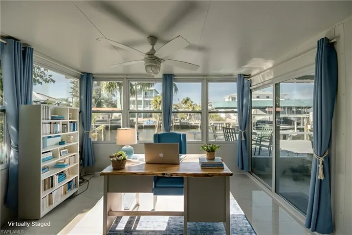 Office with a water view and a ceiling fan